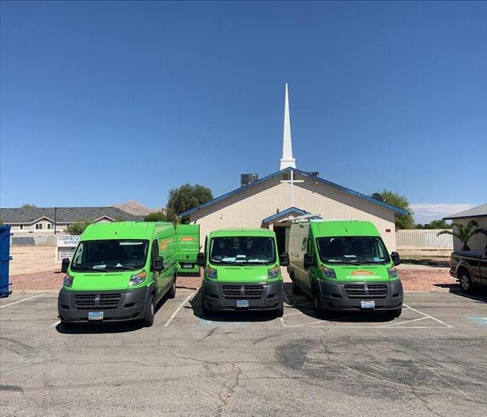 Three SERVPRO vans in front of a church.