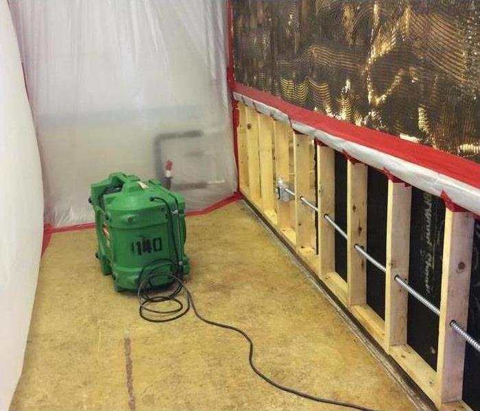 Mold behind drywall, plastic covers in wall. Concept mold containment in commercial building