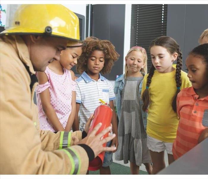 Firefighter teaching kids